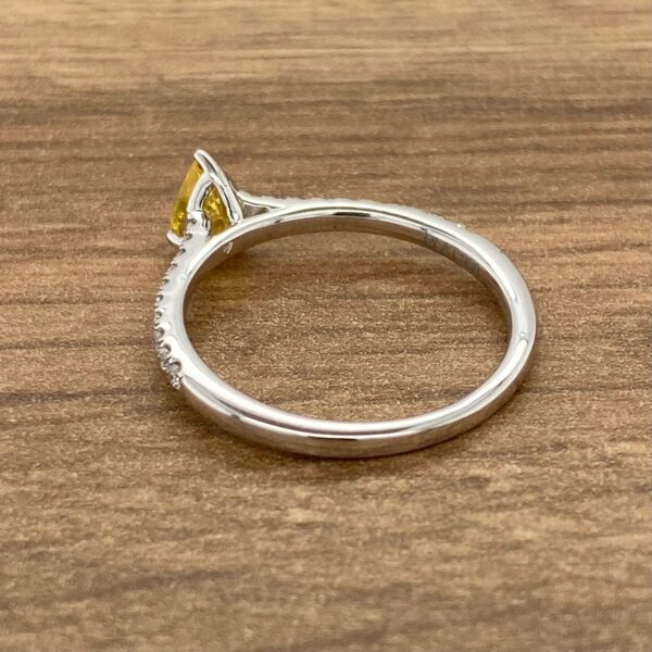 Diamond ring with yellow gemstone.