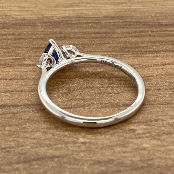 Three stone engagement ring with sapphire.