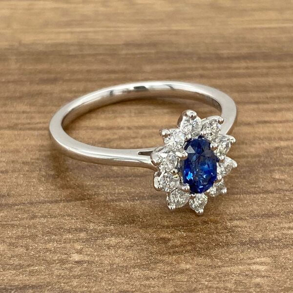 Oval sapphire engagement ring with diamonds.