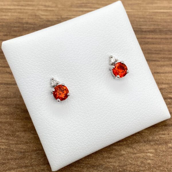 Red gemstone earrings with white diamonds.