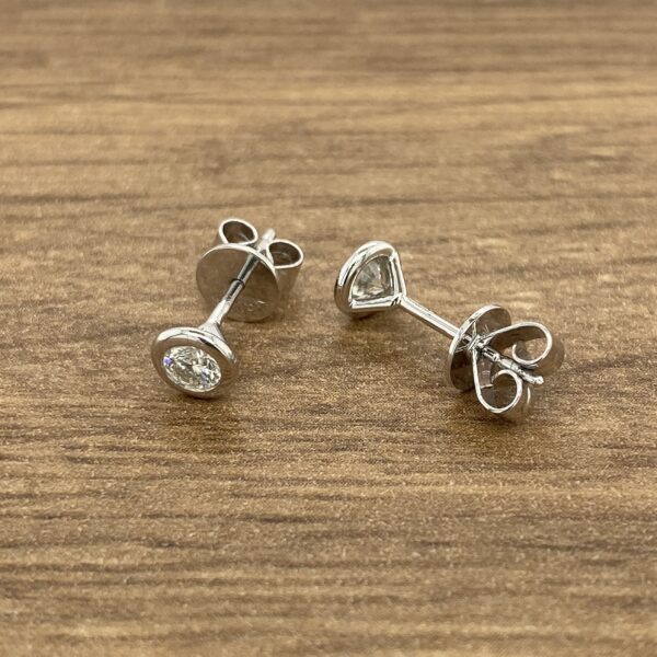 Pair of silver diamond stud earrings.