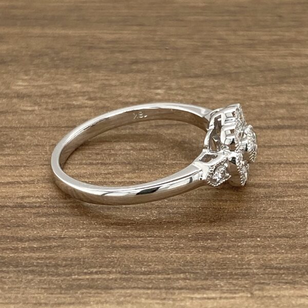 Silver ring with diamond cluster setting.