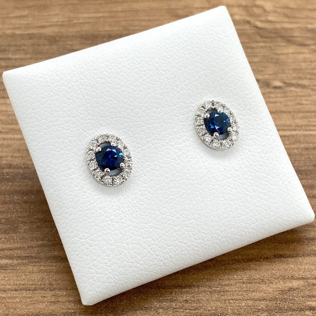 Oval sapphire and diamond halo earrings.