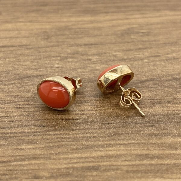 Gold earrings with red coral stones.