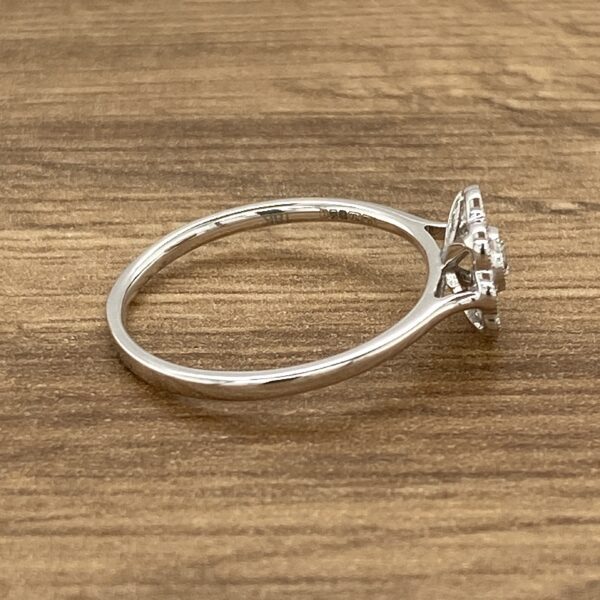 Silver ring with a diamond setting.