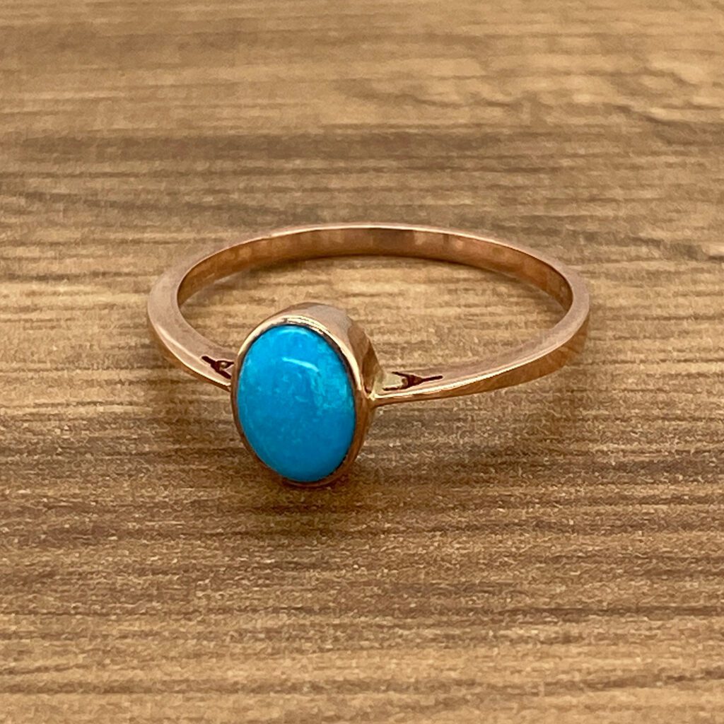 Rose gold ring with turquoise stone.