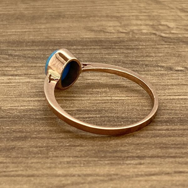 Gold ring with a blue gemstone.