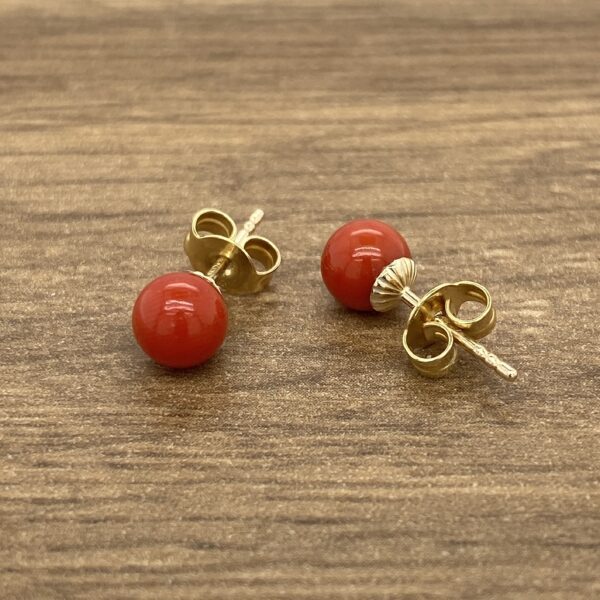 Gold earrings with red coral stones.