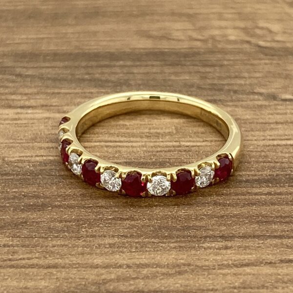 Gold band with ruby and diamond stones.