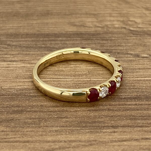 Gold band with ruby and diamond stones.