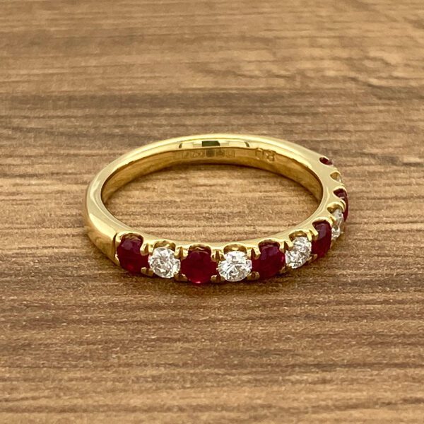 Gold band with ruby and diamond stones.