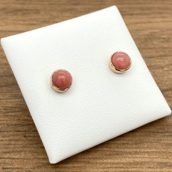 Rose gold earrings with pink stones.