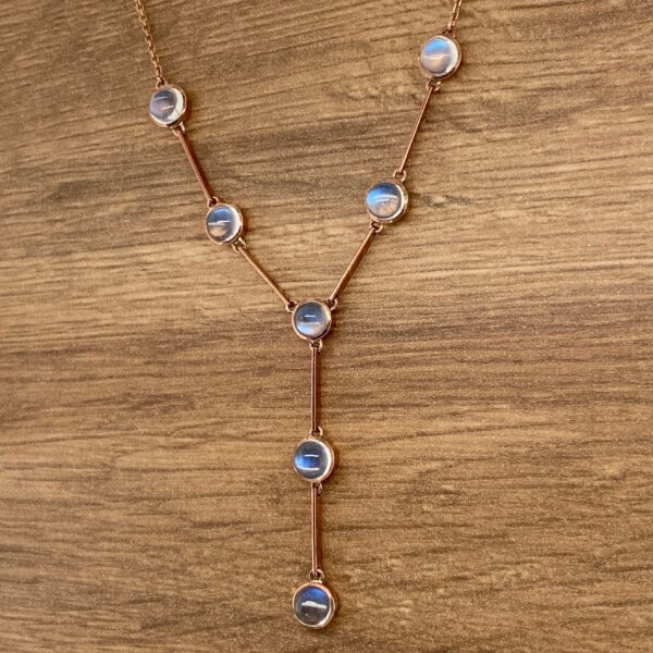 Gold necklace with round moonstone gems.