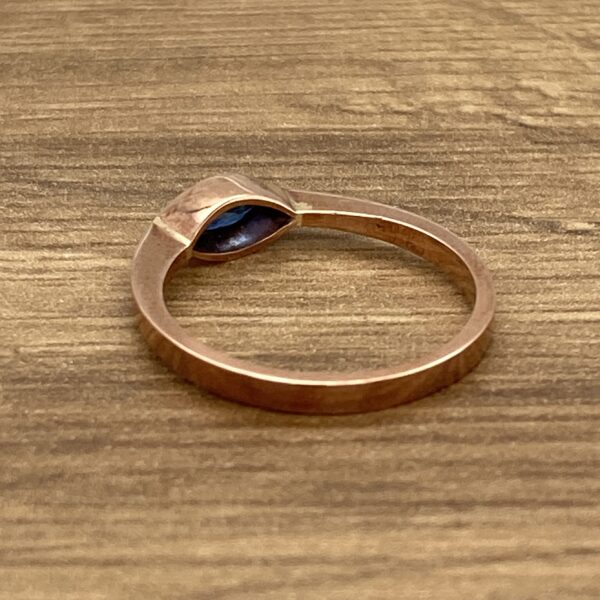 Gold ring with blue gemstone.