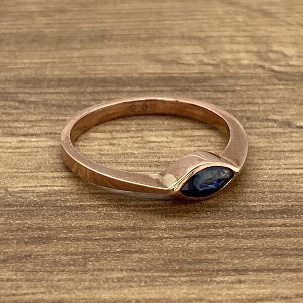 Gold ring with a blue gemstone.