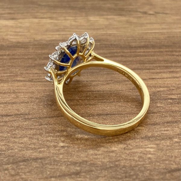 Gold ring with a blue sapphire and diamonds.