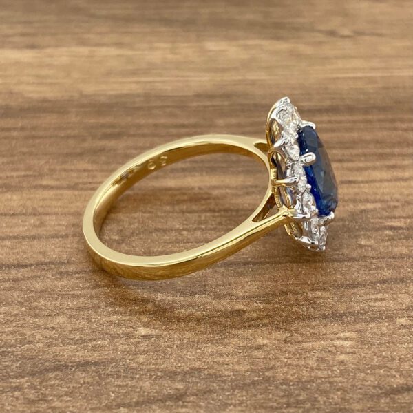 Gold ring with a blue sapphire and diamonds.