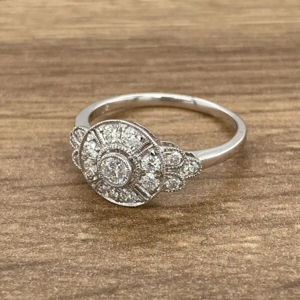 A white gold ring with a cluster of diamonds.