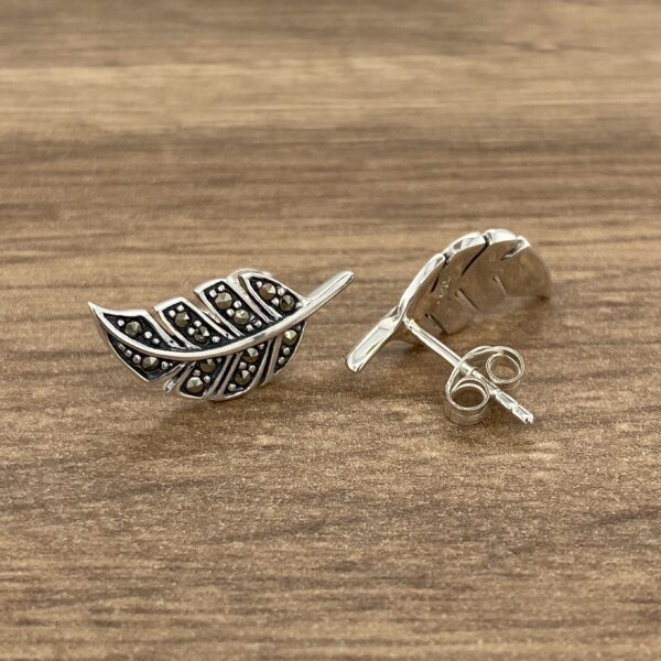 A pair of sterling silver leaf stud earrings.