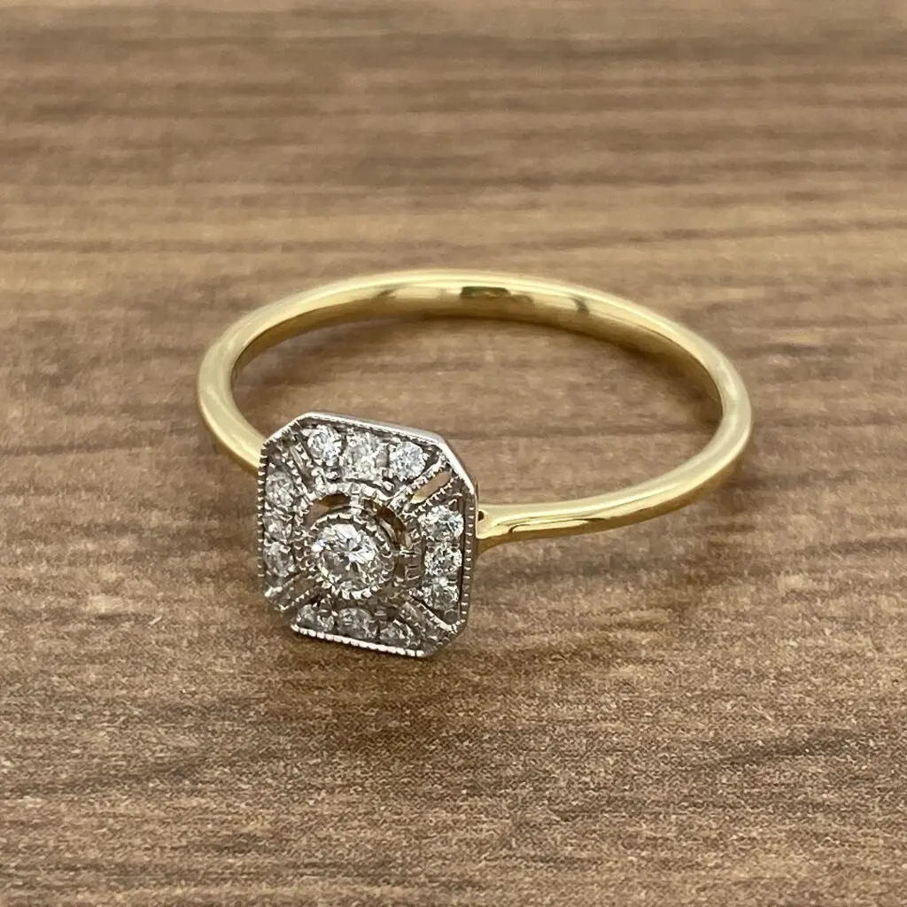 A yellow gold ring with a diamond in the center.