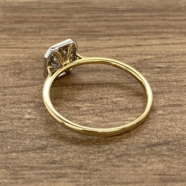 A yellow gold ring with a diamond in the center.