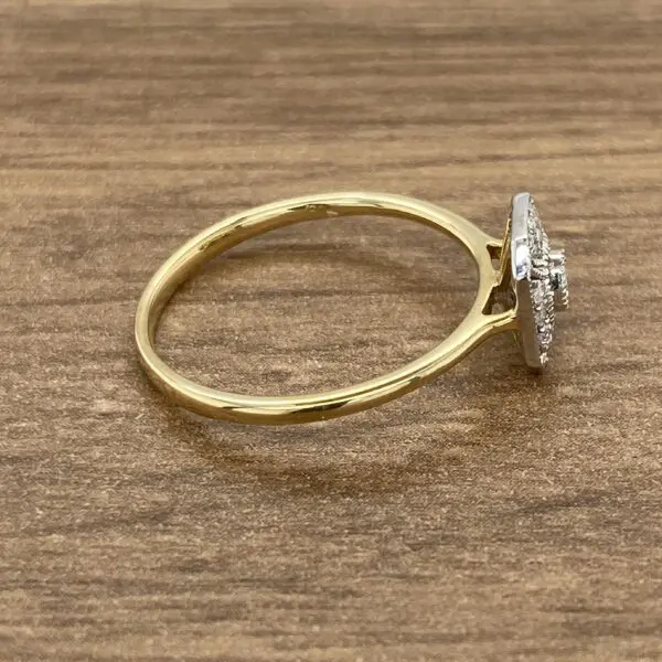 A yellow gold ring with diamonds on top.