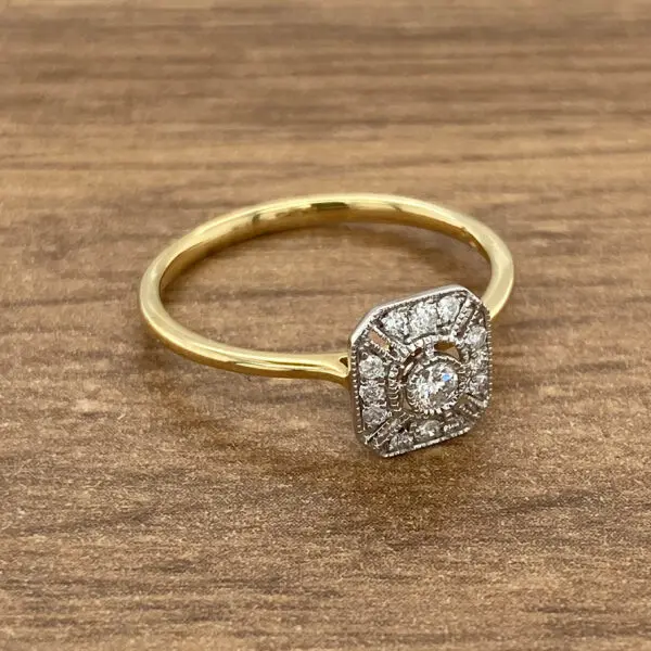 A yellow gold ring with a diamond in the center.