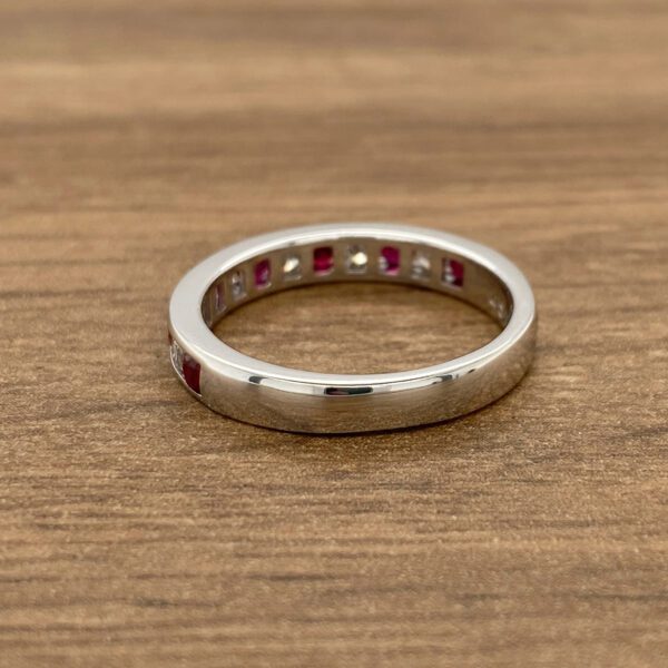 White gold band with ruby and diamond stones.