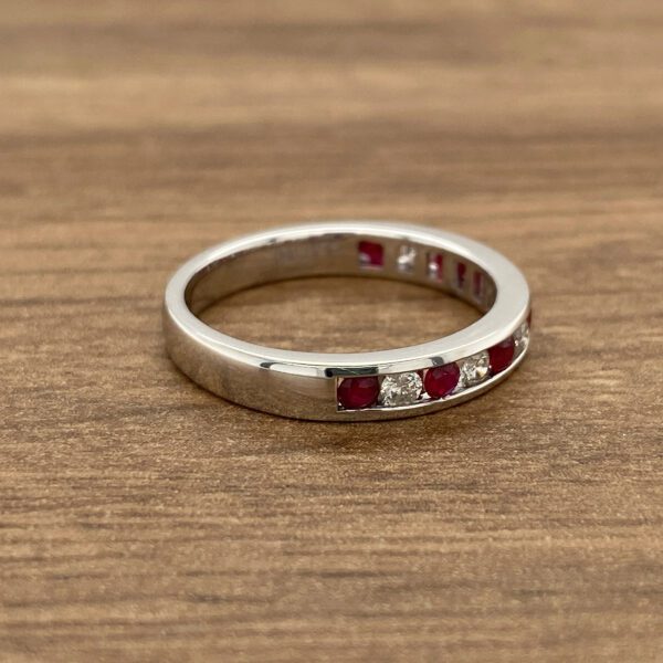 White gold band with ruby and diamond stones.