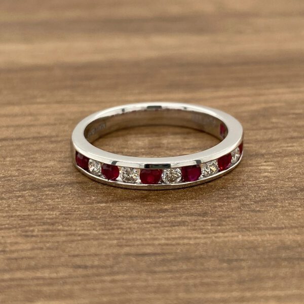 White gold ruby and diamond band ring.