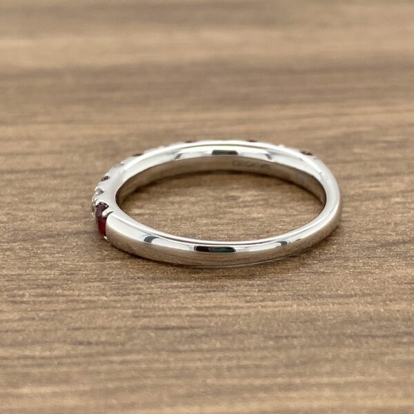 Silver band with red gemstones.