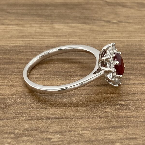 Silver ring with a red gemstone.