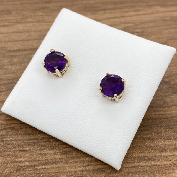 Amethyst stud earrings on a white background.