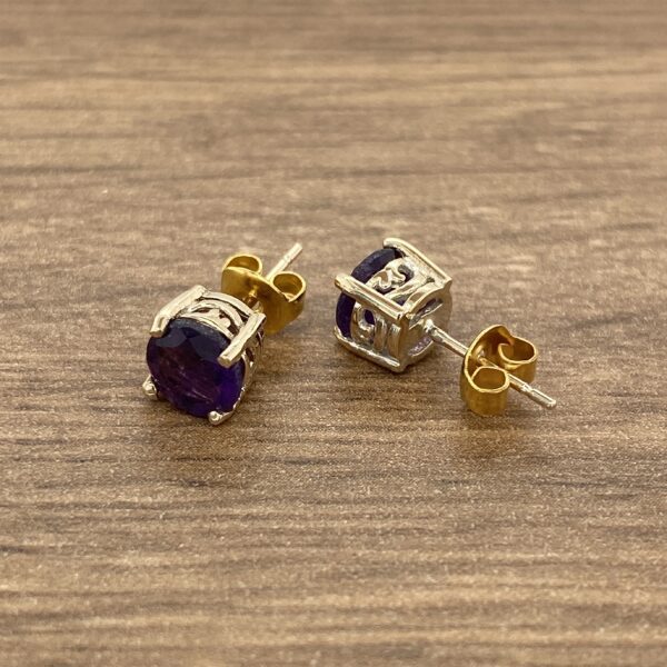 Pair of purple gemstone stud earrings.