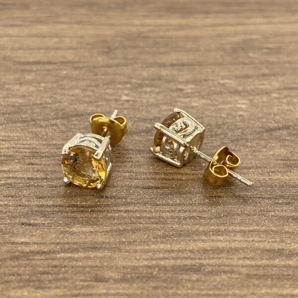 Gold and silver round gemstone earrings.