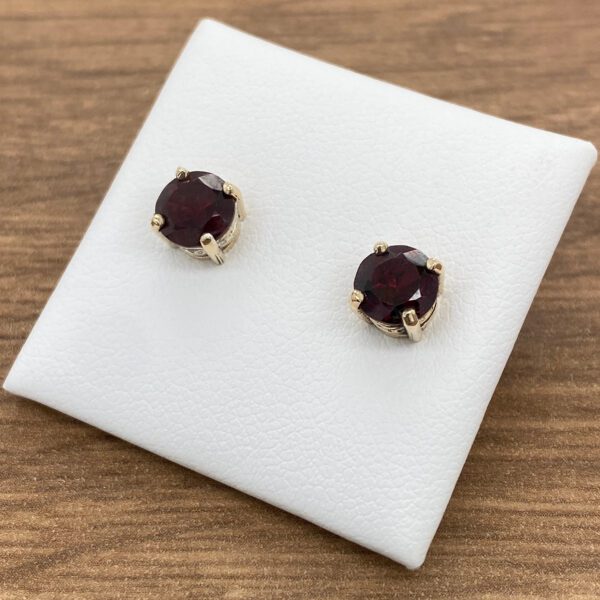 Pair of red gemstone stud earrings.