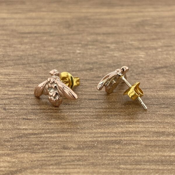 Gold and rose gold bee stud earrings.