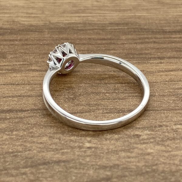 Silver ring with pink gemstone.