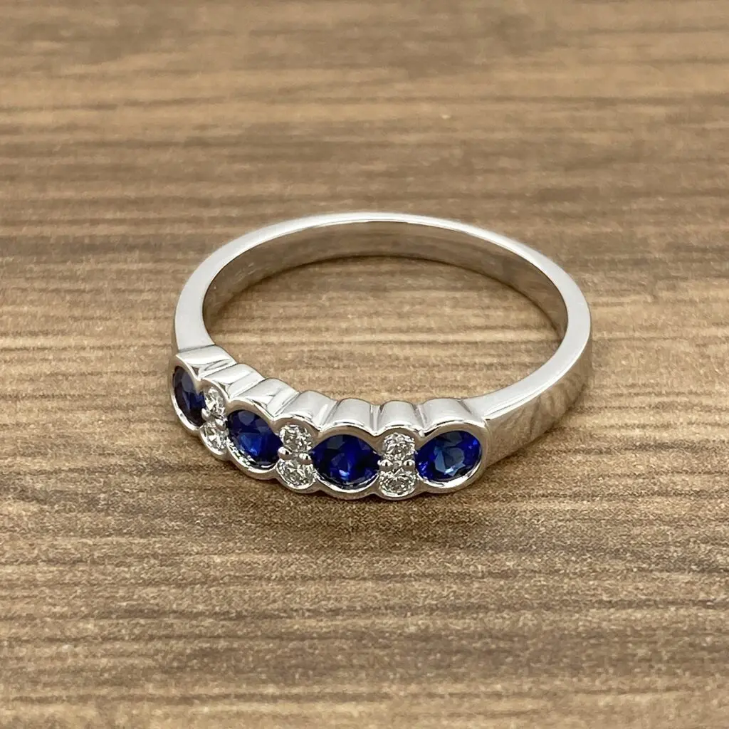 Silver ring with blue sapphires and diamonds.