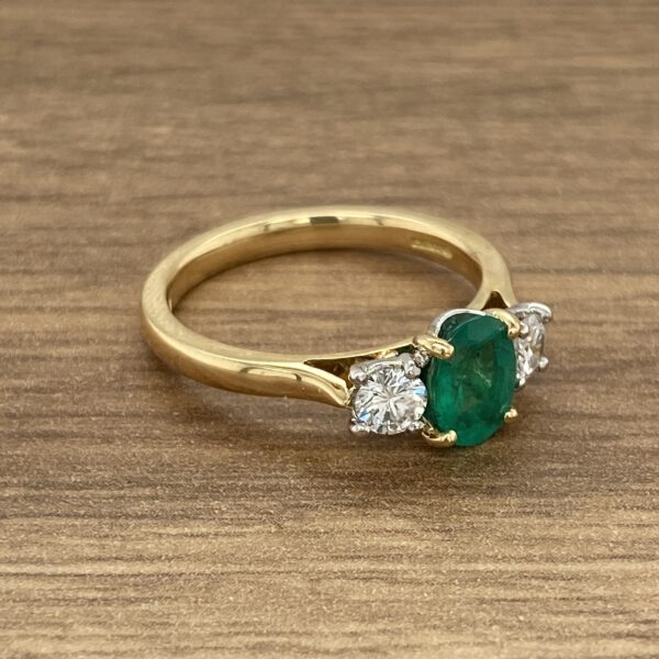 Gold ring with emerald and diamonds.