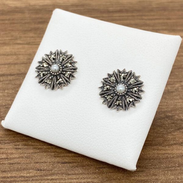 Silver earrings with pearl center and marcasite.