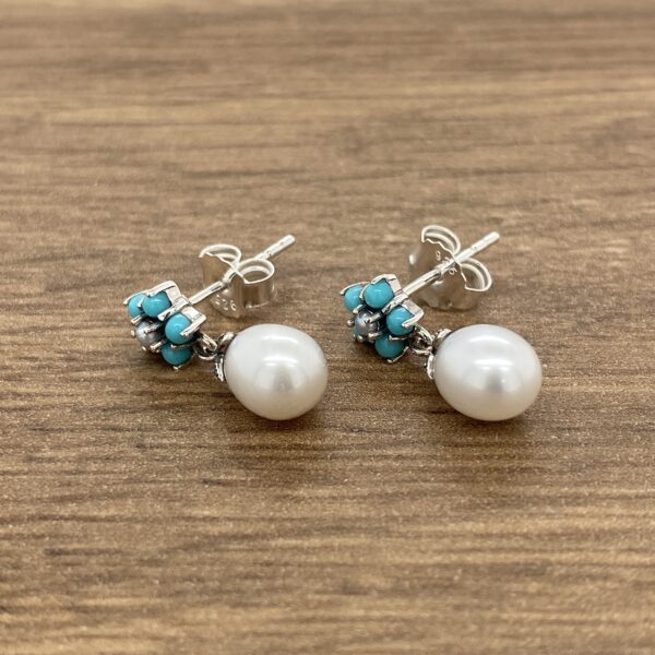 Silver earrings with turquoise and pearl drops.