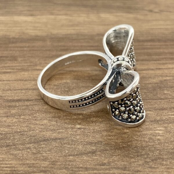 Silver ring with a bow-shaped design.