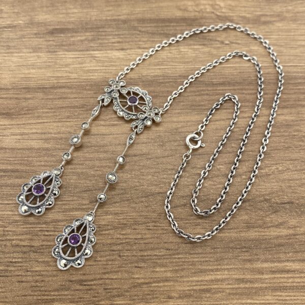 Silver necklace with amethyst stones.