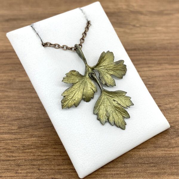 A necklace with two leaves on it.