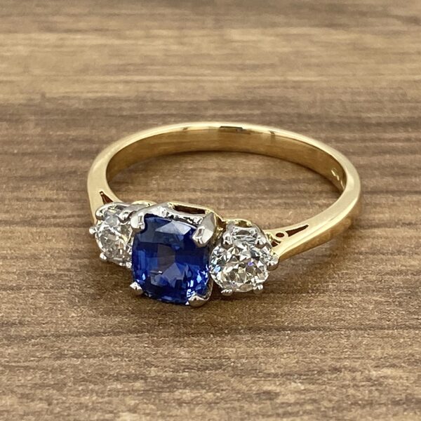 Gold ring with a sapphire and diamonds.