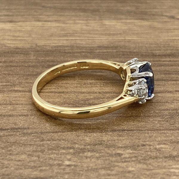 Gold ring with sapphire and diamonds.