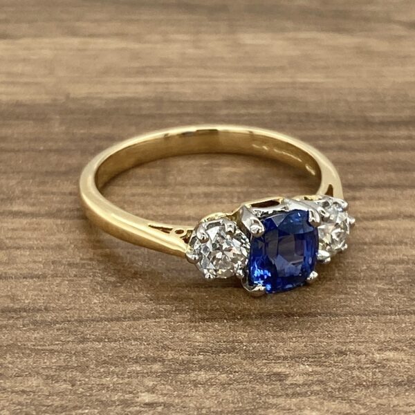 Gold ring with blue sapphire and diamonds.