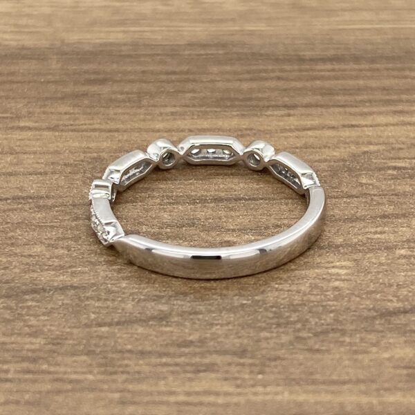 Diamond eternity band on wooden background.