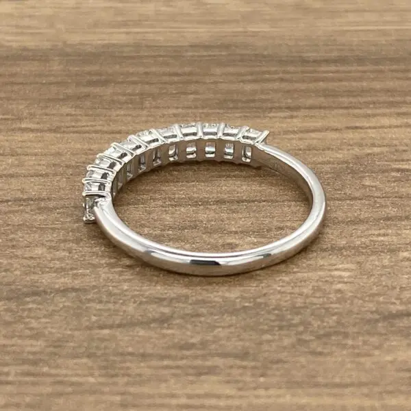 Diamond eternity band on wooden surface.